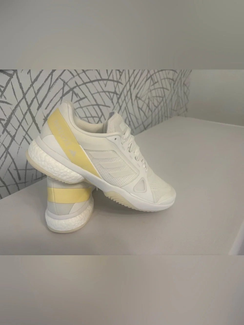 adidas Avaluxe tennis shoes in white with subtle pastel yellow accents. JQ7080